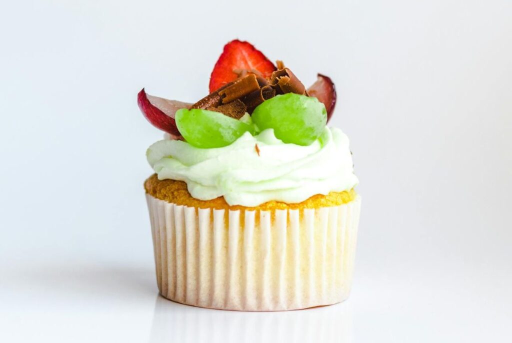 Un cupcake avec glaçage vert et des fraises. Recette pour faire des cupcakes avec des fraises et du glaçage vert